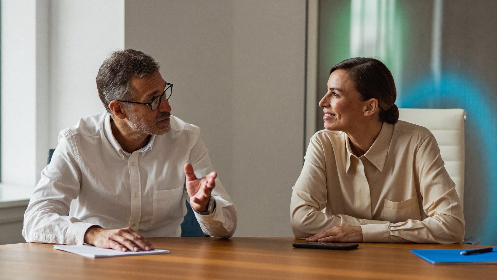 Two senior professionals in focused conversation